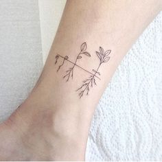 a small tattoo on the ankle of a woman