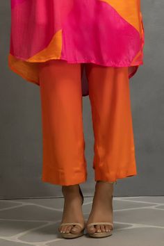 Pink and orange abstract print pleated kurta with an embroidered placket. Paired with a pant. - Aza Fashions Designer Orange Silk Kurta, Fitted Orange Kurta For Summer, Spring Orange Straight Kurta, Casual Orange Kurta For Summer, Orange Workwear Sets For Summer, Traditional Orange Sets For Spring, Summer Orange Workwear Sets, Orange Summer Workwear Sets, Summer Orange Kurta With Printed Motifs