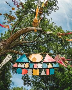 a colorful sign hanging from the side of a tree