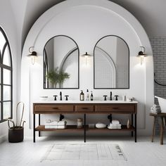 a bathroom with two sinks and mirrors on the wall next to each other in front of an arched window