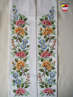 two embroidered white cloths with flowers on them