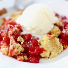 a white plate topped with fruit cobbler and ice cream