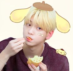 a young man is eating some food while wearing bunny ears on his head and nose