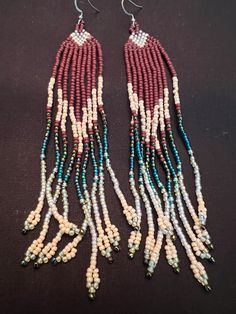 Hand made western style beaded earrings. Southwestern Dangling Beads For Jewelry Making, Southwestern Handmade Dangle Beaded Earrings, Handmade Southwestern Dangle Beaded Earrings, Southwestern Style Beaded Dangle Earrings For Festival, Southwestern Dangle Beaded Earrings For Festivals, Handmade Southwestern Beaded Dangle Earrings, Southwestern Style Dangle Beaded Earrings For Festivals, Traditional Brown Handwoven Beaded Earrings, Southwestern Beaded Fringe Dangle Earrings