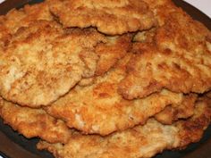 some fried food is on a black plate