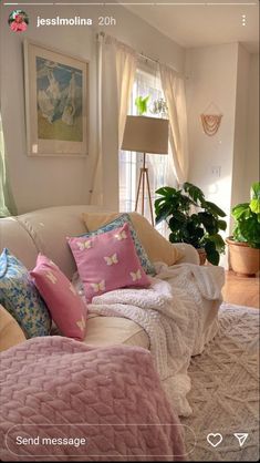 a living room filled with lots of furniture and pillows