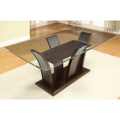 a glass dining table with two chairs and a rug on the floor in front of it