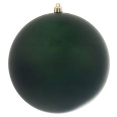 a green ornament hanging on a white wall