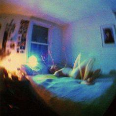 a blurry image of a person laying on a bed in a room with a window