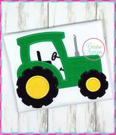 a green tractor applique on a white shirt