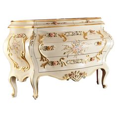 an ornate white and gold painted dresser with flowers on the front, two drawers and one door