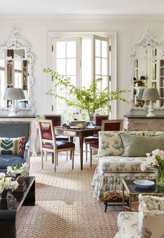 a living room filled with furniture and mirrors