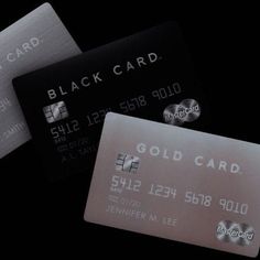 three black and white credit cards on a black background with the words gold card in silver