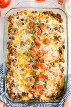 a casserole dish filled with meat, vegetables and cheese