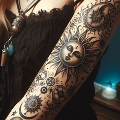 a woman's arm with sun and moon tattoos on it