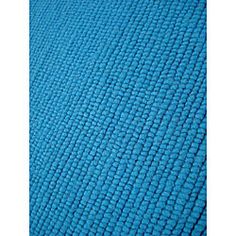 blue fabric textured with small squares on the bottom, and an area that looks like it