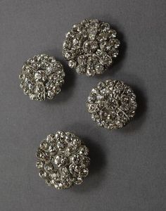 three pieces of silver colored metal on a gray surface