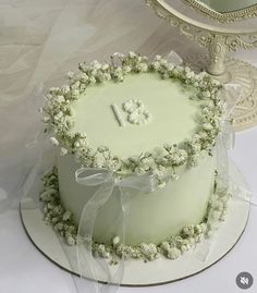 there is a white cake with flowers on the top and one number on the bottom