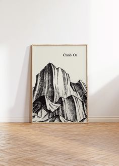 a black and white poster with the words climb on in front of a wooden floor