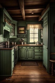 a kitchen with green cabinets and wooden floors