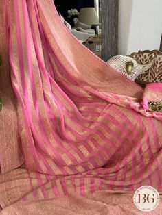 Indulge in luxury and elegance with our Banarasi Khaddi georgette saree in beautiful pink stripes. Handcrafted with intricate details, this saree exudes exclusivity and sophistication. Perfect for any occasion, this saree elevates your style and adds a touch of glamour to your wardrobe. Saree comes with a blouse piece. Fall and pico done. Fully stitched blouse shown in pictures is optional and can be purchased seperately from our blouses and croptops section. For saree video please connect with us on whatsapp @469-937-0606 Ready to be shipped in USA from San Diego, California. All pictures are original pictures. Colors may slightly vary due to pic resolution. Festival Georgette Pre-draped Saree With Border, Pink Georgette Saree With Zari Weaving, Pink Georgette Dupatta With Zari Weaving, Pink Georgette Blouse Piece For Traditional Ceremonies, Elegant Pink Blouse Piece With Zari Weaving, Elegant Pink Saree For Diwali, Elegant Pink Pre-draped Saree With Zari Weaving, Elegant Georgette Dupatta With Zari Weaving, Elegant Pink Chanderi Saree