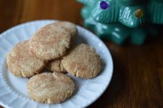 some cookies are on a white plate next to a green elephant