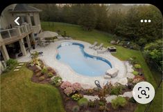 an aerial view of a backyard with a swimming pool