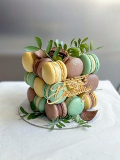 there is a cake decorated with macaroons and leaves