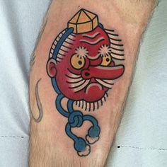 a man with a tattoo on his leg that has an image of a chinese god