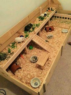 a wooden bench filled with lots of different types of animals and plants on top of it