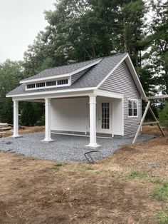 a garage with a swing set in front of it