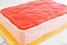 there is a cake with red icing on it