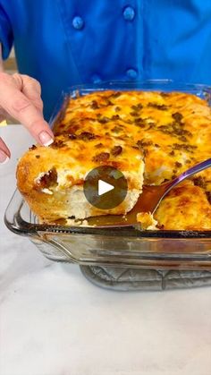 a person cutting into a casserole dish with a knife and fork in it