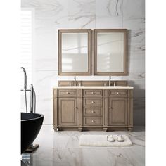 a bathroom with double sinks and two mirrors on the wall next to a bathtub