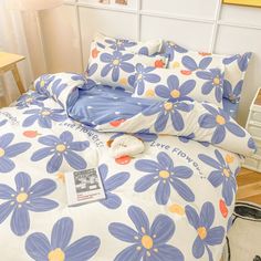 a bed with blue and yellow flowers on it