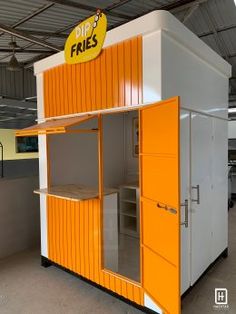 an orange and white portable kitchen in a warehouse