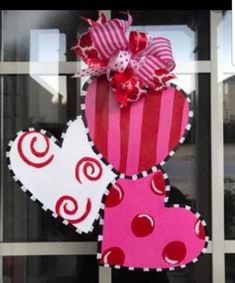 a pink and red heart shaped door hanger