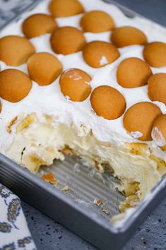 a close up of a cake in a pan with icing and some eggs on top