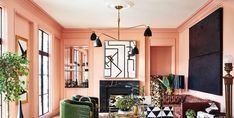 a living room with pink walls and furniture