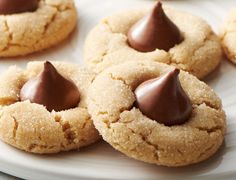 some cookies with chocolate on top are sitting on a plate