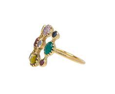 Playfully sophisticated with a French, modern style, this Dorette ring is an earthy combination of mixed toned multi-gems. Each of the stones - including tourmaline, tsavorite, garnet, chrysoberyl, sapphire, emerald, ruby and tanzanite - are set in 18K yellow gold bezels and backed with sterling silver. They form a square frame around the center stone which is centered on the polished 18K yellow gold band. With its eclectic, one-of-a-kind design, it adds an element of colorful elegance to any co Luxury Multicolor Multi-stone Sapphire Ring, Oval Multicolor Multi-stone Rings, Multicolor Oval Multi-stone Cluster Ring, Luxury Multicolor Emerald Gemstone Ring, Luxury Multicolor Rings With Gemstone Accents, Multicolor Multi-stone Emerald Oval Ring, Elegant Multicolor Multi-stone Emerald Ring, Multicolor Tourmaline Rings With Gemstone Accents, Multicolor Tourmaline Rings With Accent Stones