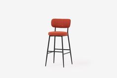 an orange stool with a black frame and backrest, in front of a white background