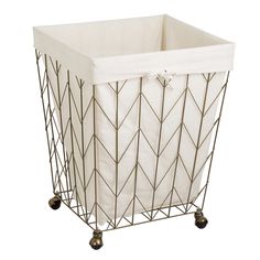 a metal basket with wheels and a white cover on the bottom is sitting in front of a white background