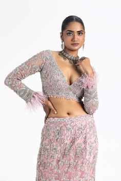 Make a statement in our pink net fishtailed lehenga set. This set features a long-sleeved choli and dupatta intricately embroidered with silver zari, dabka, sequins, and crystals. Perfect for adding a touch of elegance to your special occasions. Glamorous Fitted Anarkali Set With Sheer Dupatta, Pink Sequined Palazzo Set For Wedding, Pink Long Sleeve Palazzo Set With Intricate Embroidery, Pink Long Sleeve Sequin Set, Glamorous Pink Lehenga With Intricate Embroidery, Pink Embellished Long Sleeve Sets, Pink Long Sleeve Embellished Sets, Pink Party Wear Sets With Unstitched Blouse, Glamorous Fitted Anarkali Set With Intricate Embroidery