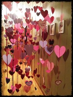 a bunch of hearts hanging from the side of a wall