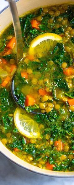 a pot full of soup with lemons and spinach