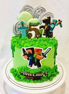 a birthday cake with the number five on it and decorations for minecraft characters in green frosting