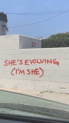 graffiti on the side of a building that says she's involving i'm she