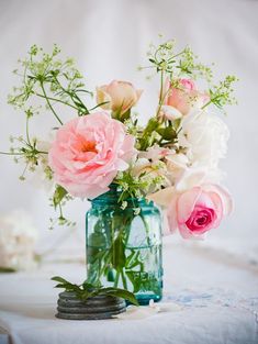 a vase filled with pink and white flowers on top of a table next to an instagram page