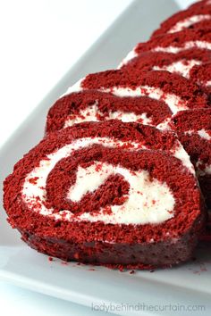 red velvet roll with white frosting on a plate